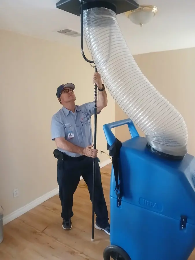 Furnace Tune-Up technician using HEPA equipment in Amity